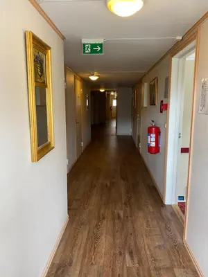 an empty hallway in a building with a fire hydrant at Eidsvåg Fjordhotell in Eidsvåg