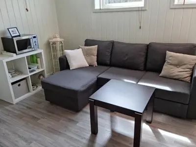a living room with a couch and a coffee table at Bårdshaug Studio Apartment in Orkanger