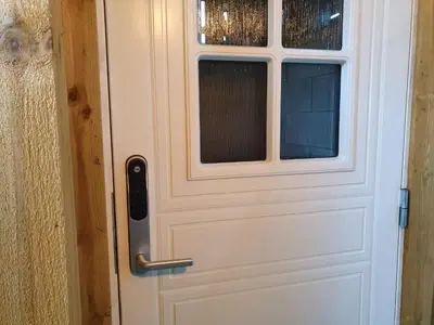 a white door with a window on it at Bårdshaug Studio Apartment in Orkanger