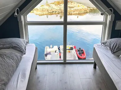 a room with a window with a boat in the water at 8 person holiday home in Urangsvåg in Ervik