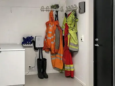 a room with coats and umbrellas hanging on a wall at 8 person holiday home in Urangsvåg in Ervik