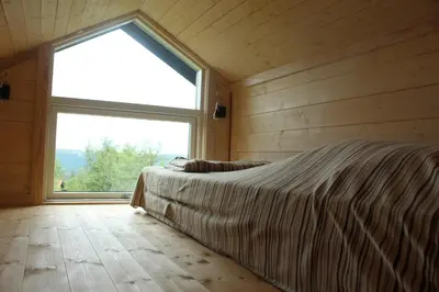 a bedroom with a bed and a large window at Lev-Vel - 10 person cabin in Ål