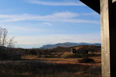 a view of a field with mountains in the distance at Lev-Vel - 10 person cabin in Ål