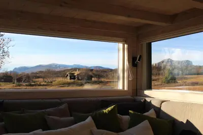 a living room with a couch and a large window at Lev-Vel - 10 person cabin in Ål