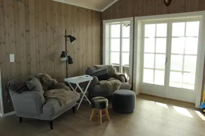 a living room with two chairs and a table at Torshaug 4 bedroom cabin in Gol
