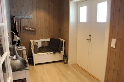 a room with a white chair and a door at Torshaug 4 bedroom cabin in Gol