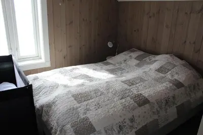 a bedroom with a bed with a quilt on it at Torshaug 4 bedroom cabin in Gol