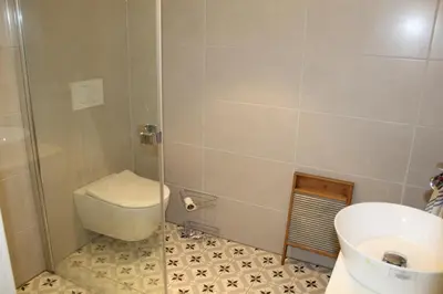 a bathroom with a shower with a toilet and a sink at Torshaug 4 bedroom cabin in Gol