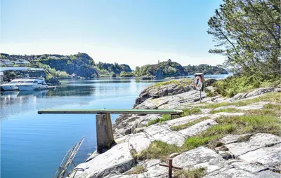 a table sitting on the side of a river at 2 Bedroom Cozy Home In Hauglandshella in Kolavåg