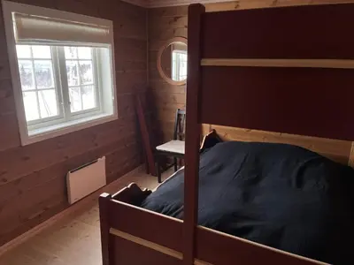 a bedroom with a bunk bed and a window at Luxembu - 4 bedroom cabin with a fantastic view in Gol