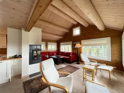 a living room with a red couch and chairs at Luxembu - 4 bedroom cabin with a fantastic view in Gol