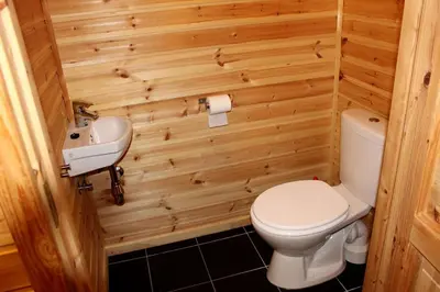 a small bathroom with a toilet and a sink at Linnaeus - 6 person cabin in Ål