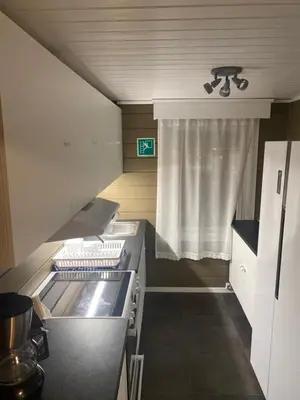 a small kitchen with a sink and a window at Frimannsbuda in Selje