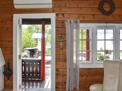 a room with a door open to a porch at Cozy Cottage Retreat in Trend-By Traum in Frei