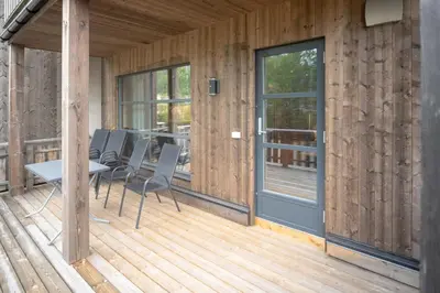 a wooden deck with a table and chairs on it at Trysiltunet 16b in Trysil