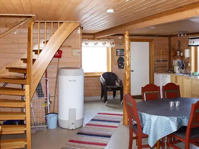a room with a table and a staircase in a cabin at 6 person holiday home in Brekstad in Brekstad