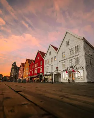 a row of buildings on a street at sunset at Hotel No13 in Bergen
