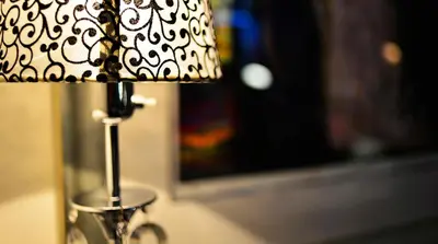 a lamp with a black and white shade on a table at Hotel No13 in Bergen