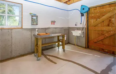 a bathroom with a wooden table and a sink at 2 Bedroom Amazing Apartment In Vestnes in Vestnes