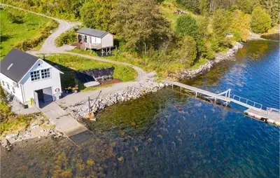 an aerial view of a house next to a body of water at 2 Bedroom Amazing Apartment In Vestnes in Vestnes