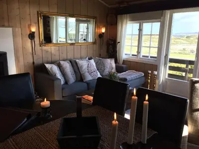 a living room with a couch and a table with candles at Kjøniksbu - 3 bedroom cabin in Ål