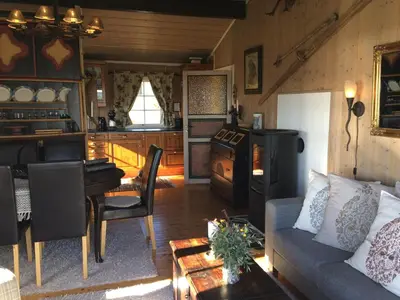 a living room with a couch and a table at Kjøniksbu - 3 bedroom cabin in Ål