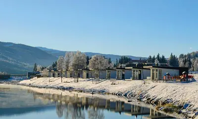 a row of houses next to a body of water at Topcamp Hallingdal - Ål in Ål