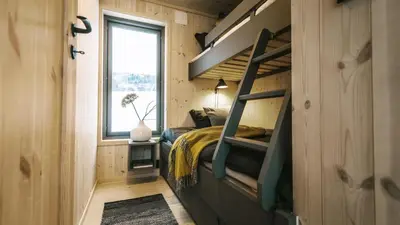 a bedroom in a tiny house with a bunk bed at Topcamp Hallingdal - Ål in Ål