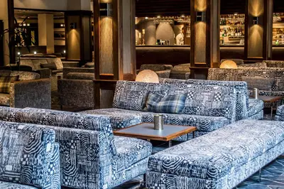 a lobby with couches and tables in a restaurant at Hotel Alexandra Loen in Loen