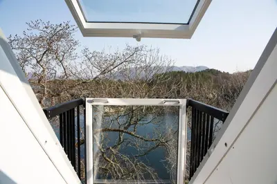 a window on a balcony with a view of the water at Skjerjehamn in Ånneland