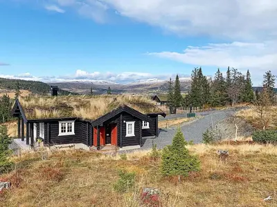 a small black house with a grass roof at 6 person holiday home in Svingvoll in Svingvoll