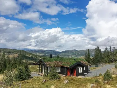 a small house with a green roof on a field at 6 person holiday home in Svingvoll in Svingvoll