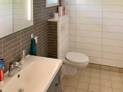 a bathroom with a white toilet and a sink at 6 person holiday home in ETNE in Etnesjøen