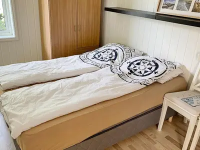 a bed with two pillows on top of it at 6 person holiday home in ETNE in Etnesjøen