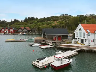 a boat is docked at a dock in the water at 6 person holiday home in Urangsvåg in Steinsbø