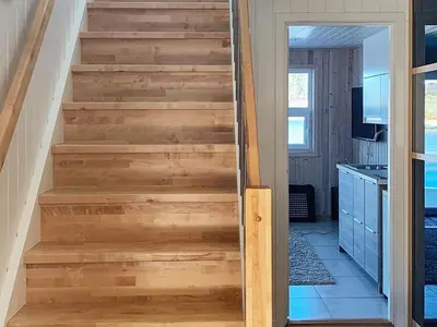 a stairway in a house with wooden steps at 6 person holiday home in Urangsvåg in Steinsbø