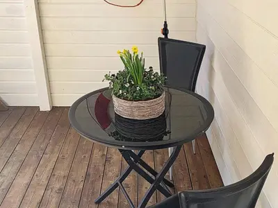 a glass table with a basket of flowers on it at 6 person holiday home in Urangsvåg in Steinsbø