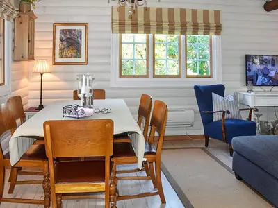 a dining room with a table and chairs at Family Oasis with Lake View-By Traum in Ålesund