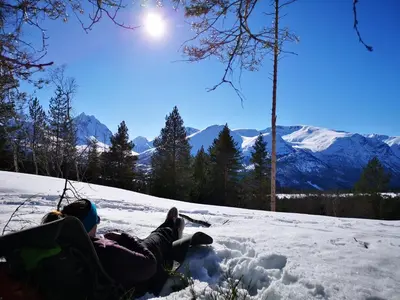 a person laying in the snow in the snow at Romsdalseggen Lodge in Isfjorden