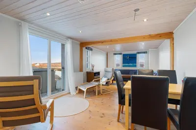 a dining room with a table and chairs at Sveggvika Guesthouse in Averoy