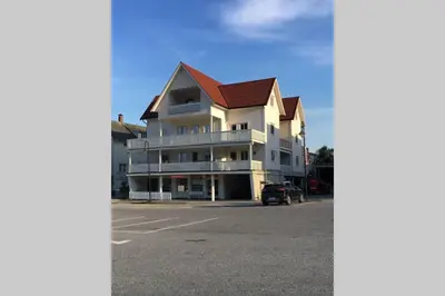 a large white building with a red roof at Balestrand Fjordapartments Holmen 19A in Balestrand