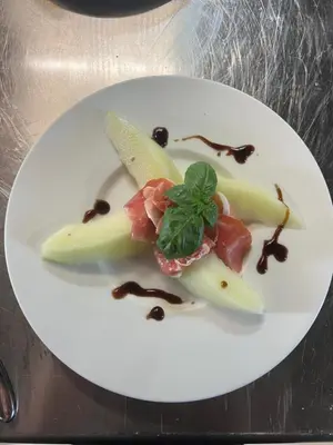 a white plate with a piece of food on it at Eidegrend Boutique Hotel in Eikelandsosen