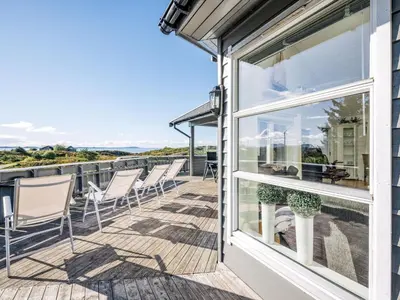 a balcony with chairs and a view of the ocean at Holiday Home Sjøbuvågen by Interhome in Korssund