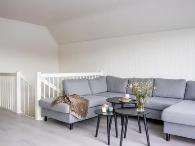 a living room with a couch and a table at Holiday Home Brosme by Interhome in Bømlo