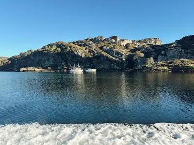 two boats in a body of water with a mountain at Holiday Home Brosme by Interhome in Bømlo