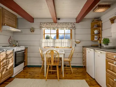 a kitchen with a table and chairs and a window at Chalet Eiketun by Interhome in Olden