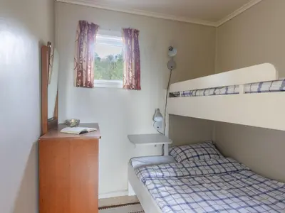 a bedroom with a bunk bed and a window at Holiday Home Fjordglytt by Interhome in Onarheim
