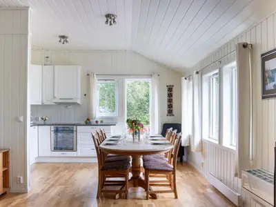 a kitchen and dining room with a table and chairs at Holiday Home Fjordglytt by Interhome in Onarheim