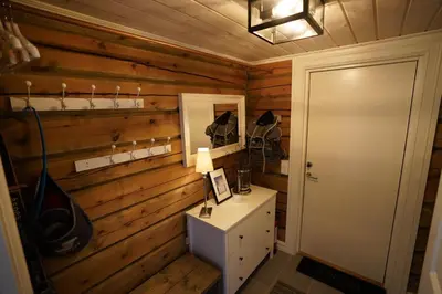 a room with a wooden wall with a table and a mirror at Lake View Apartment 2 bedrooms and loft in Stranda