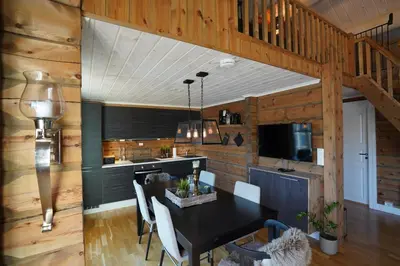 a kitchen and dining room with a black table and chairs at Lake View Apartment 2 bedrooms and loft in Stranda